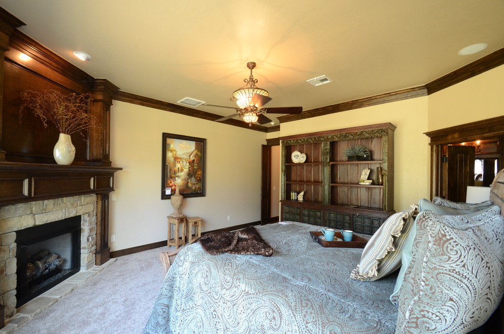 Inspiration for a large timeless master carpeted bedroom remodel in Oklahoma City with yellow walls, a corner fireplace and a stone fireplace