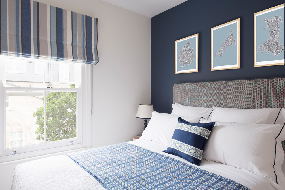 Example of a transitional bedroom design in London with blue walls