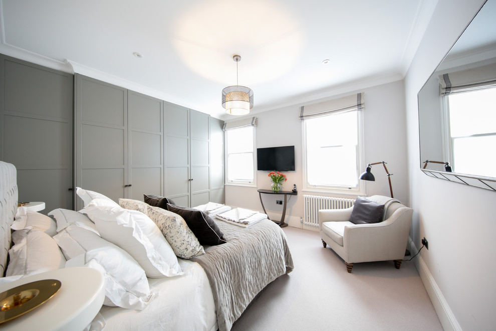 Design ideas for a master bedroom in London with grey walls.
