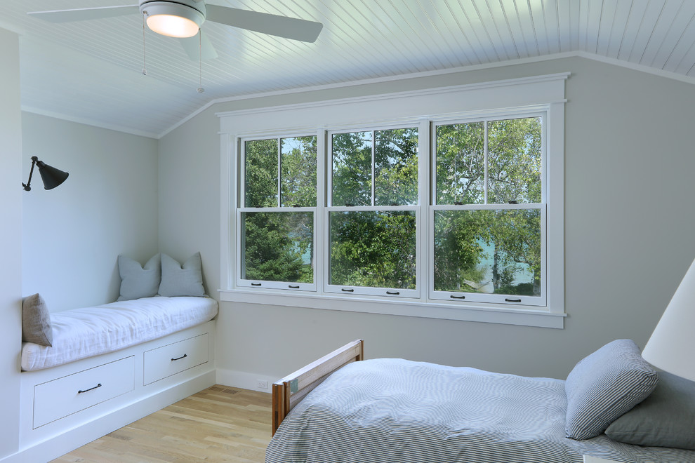 Example of a small cottage guest light wood floor and brown floor bedroom design in Other with beige walls