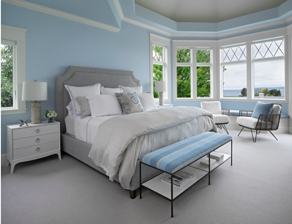 Inspiration for a large coastal guest carpeted and beige floor bedroom remodel in Other with blue walls