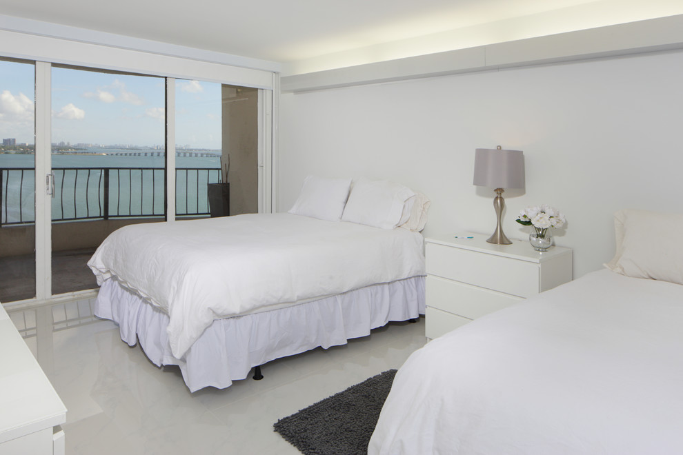 Ejemplo de dormitorio minimalista con paredes blancas y suelo de baldosas de porcelana