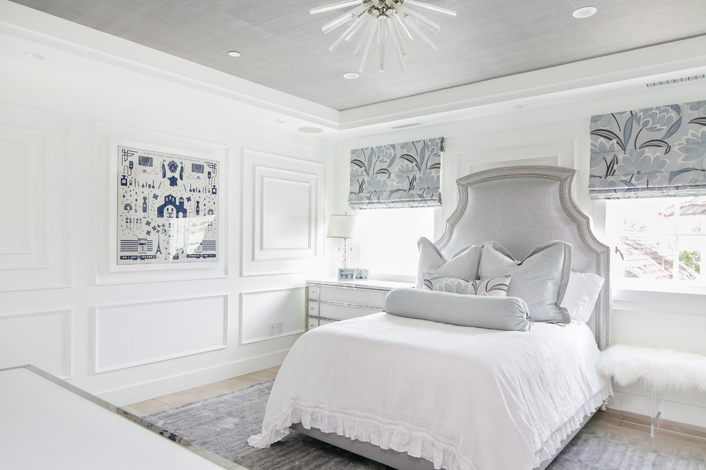 Design ideas for a nautical bedroom in Orange County with white walls and light hardwood flooring.