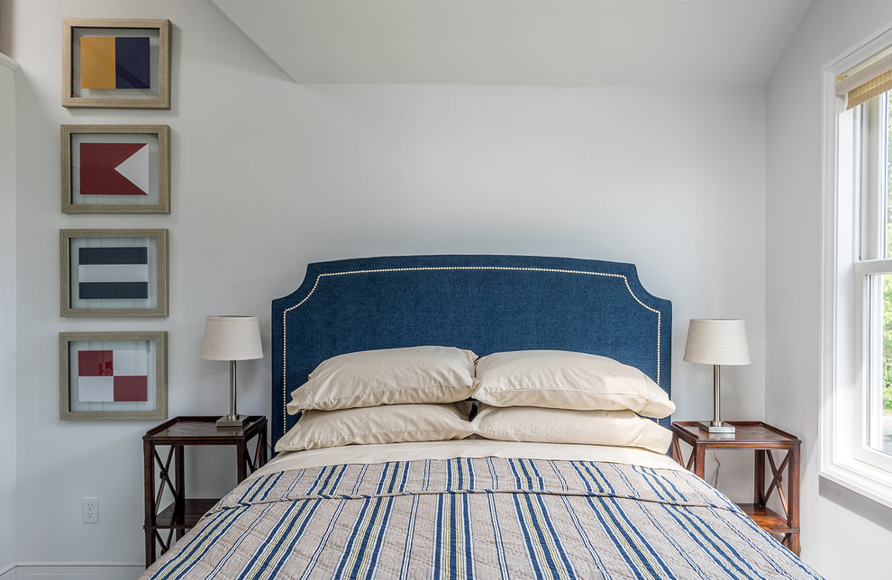 Example of a transitional bedroom design in Portland Maine with white walls