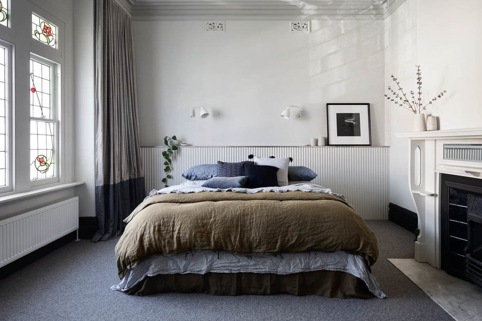 Aménagement d'une grande chambre avec moquette contemporaine avec un mur beige, une cheminée standard, un manteau de cheminée en métal et un sol gris.