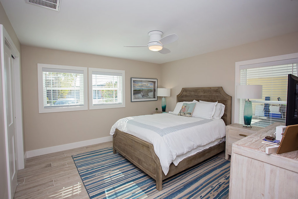 Medium sized coastal master bedroom in Miami.