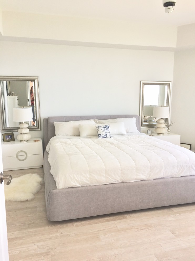 This is an example of a small beach style master bedroom in Orlando with white walls, porcelain flooring and beige floors.