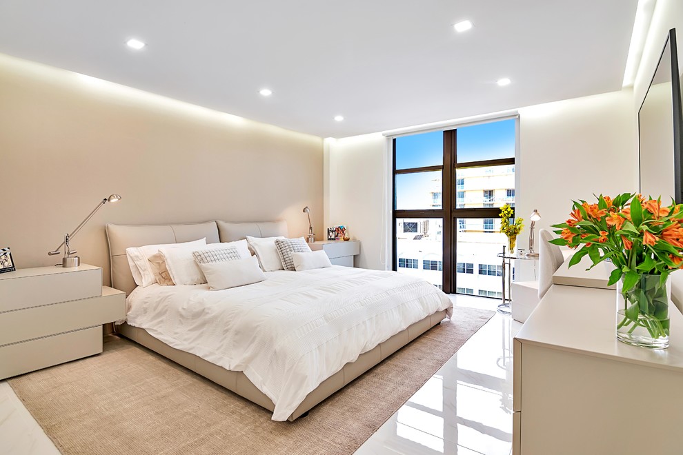 Inspiration for a mid-sized modern master porcelain tile and white floor bedroom remodel in Miami with beige walls