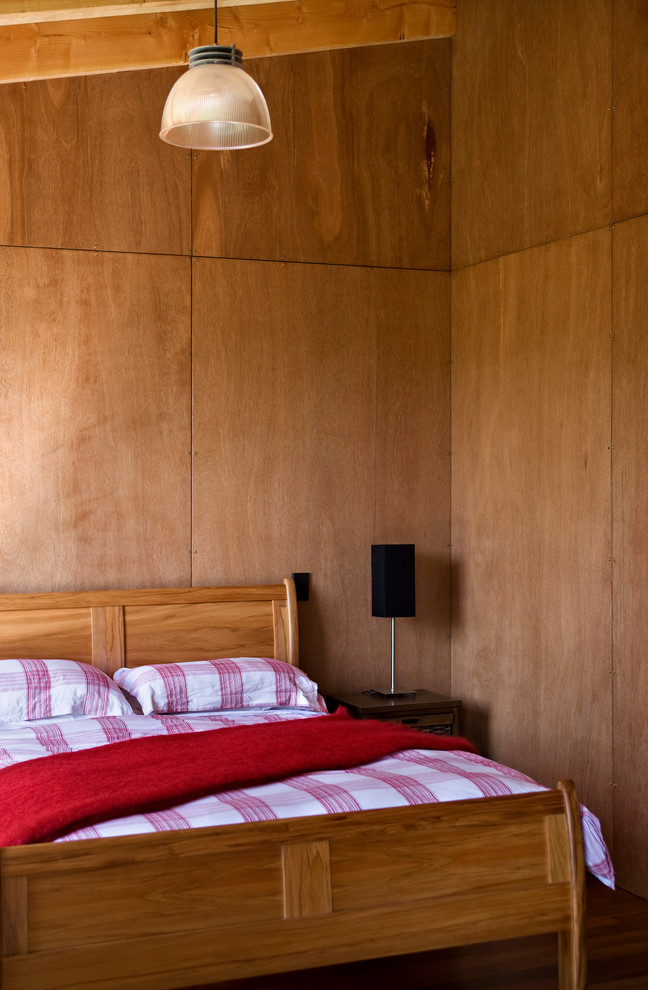 Bild på ett rustikt sovrum, med bruna väggar