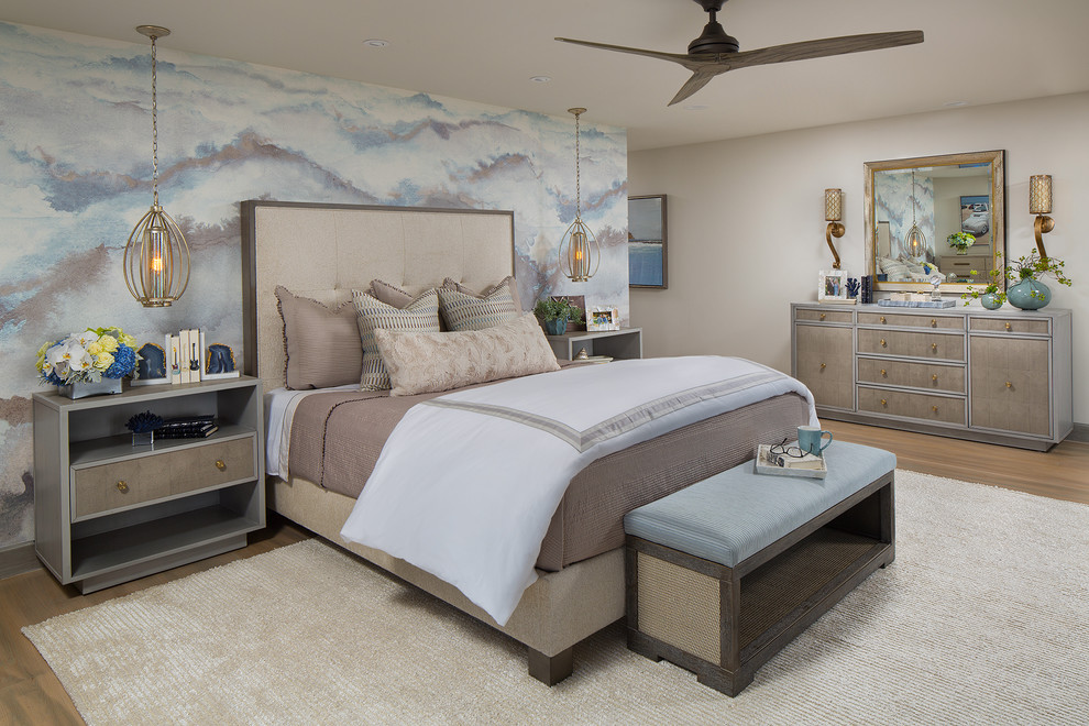 Photo of a medium sized coastal master bedroom in Orange County with beige floors, multi-coloured walls and light hardwood flooring.