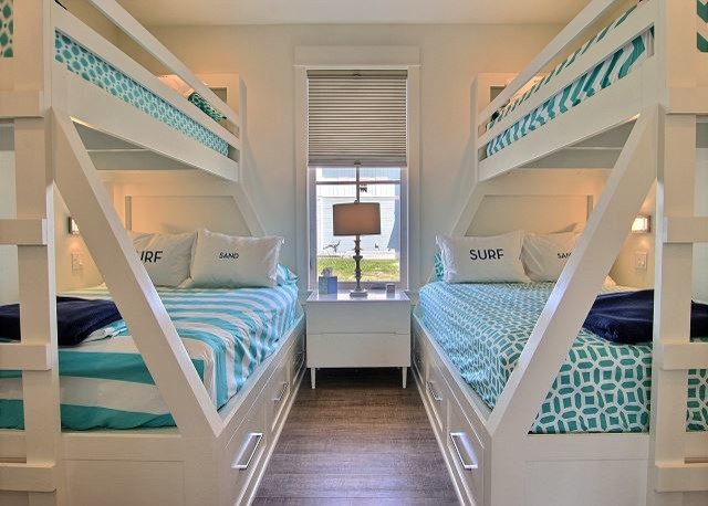 Inspiration for a small coastal guest medium tone wood floor and brown floor bedroom remodel in Austin with white walls