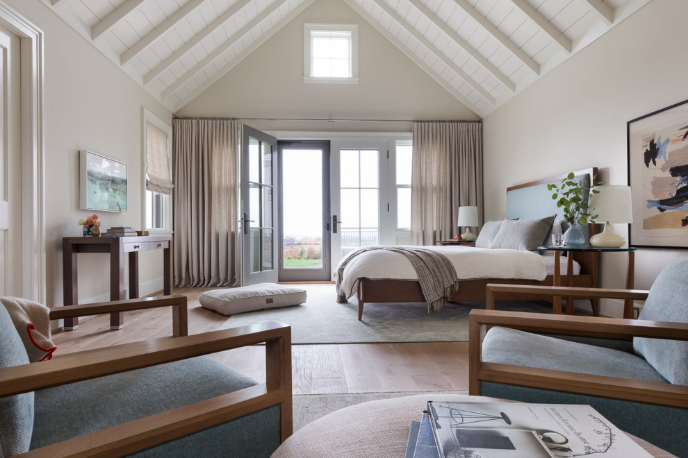 Example of a beach style medium tone wood floor, brown floor, exposed beam, shiplap ceiling and vaulted ceiling bedroom design in San Francisco with beige walls
