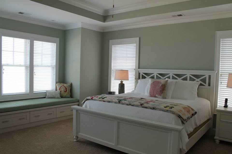 Photo of a beach style guest bedroom in Charleston with beige walls, carpet and beige floors.