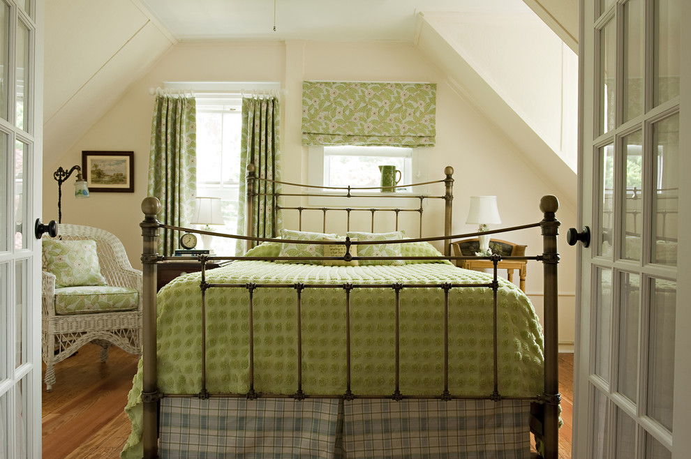 Medium sized beach style guest bedroom in New York with white walls, medium hardwood flooring and no fireplace.