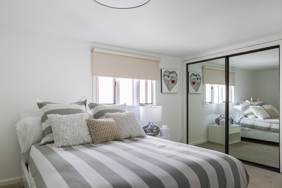 Example of a small beach style guest light wood floor bedroom design in Los Angeles with white walls