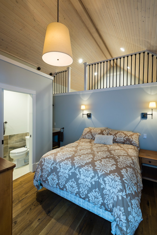 Photo of a medium sized beach style guest bedroom in Seattle with grey walls, medium hardwood flooring and brown floors.