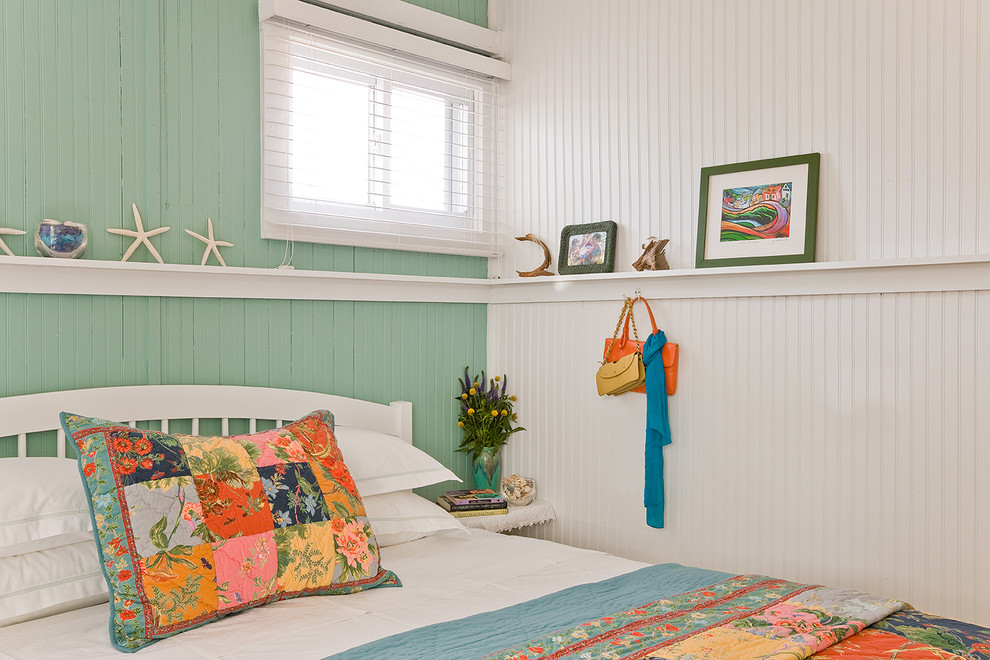 Small coastal master bedroom in Boston with multi-coloured walls and light hardwood flooring.