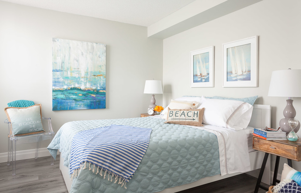 Inspiration for a mid-sized coastal master medium tone wood floor and gray floor bedroom remodel in Toronto with white walls