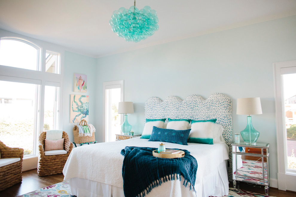 Beach style dark wood floor and brown floor bedroom photo in Other with blue walls