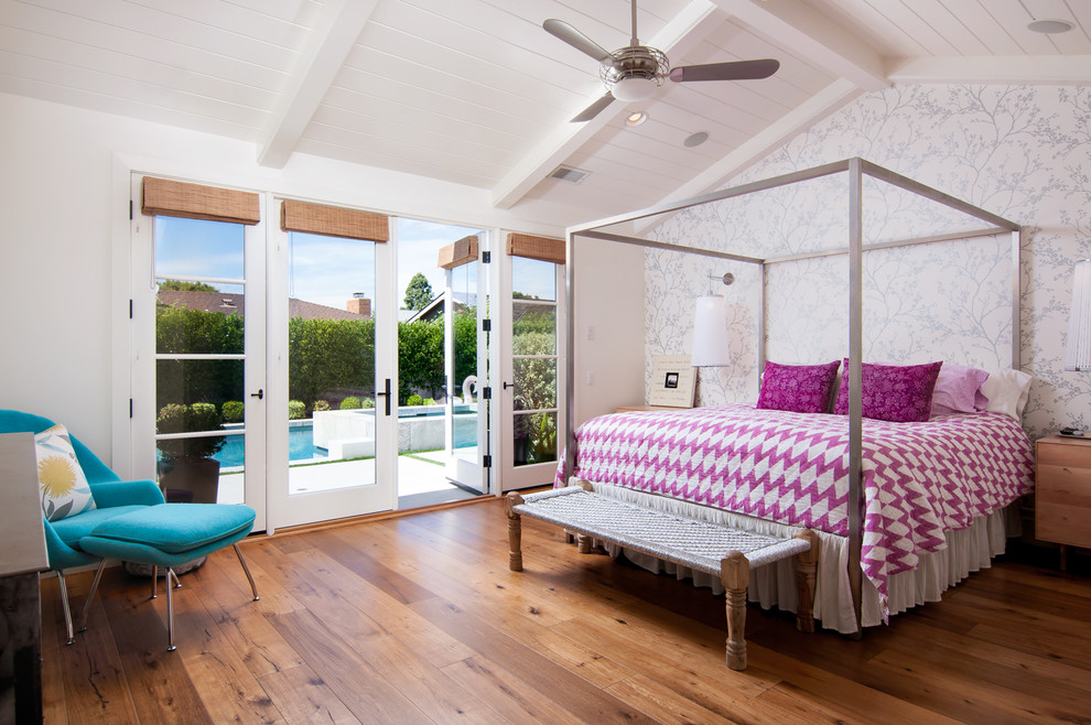 Photo of a beach style guest bedroom in Orange County with white walls, medium hardwood flooring and no fireplace.