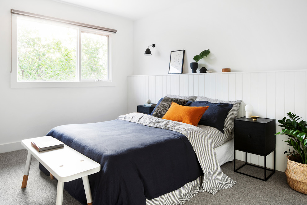This is an example of a medium sized nautical guest bedroom in Melbourne with white walls, carpet and grey floors.