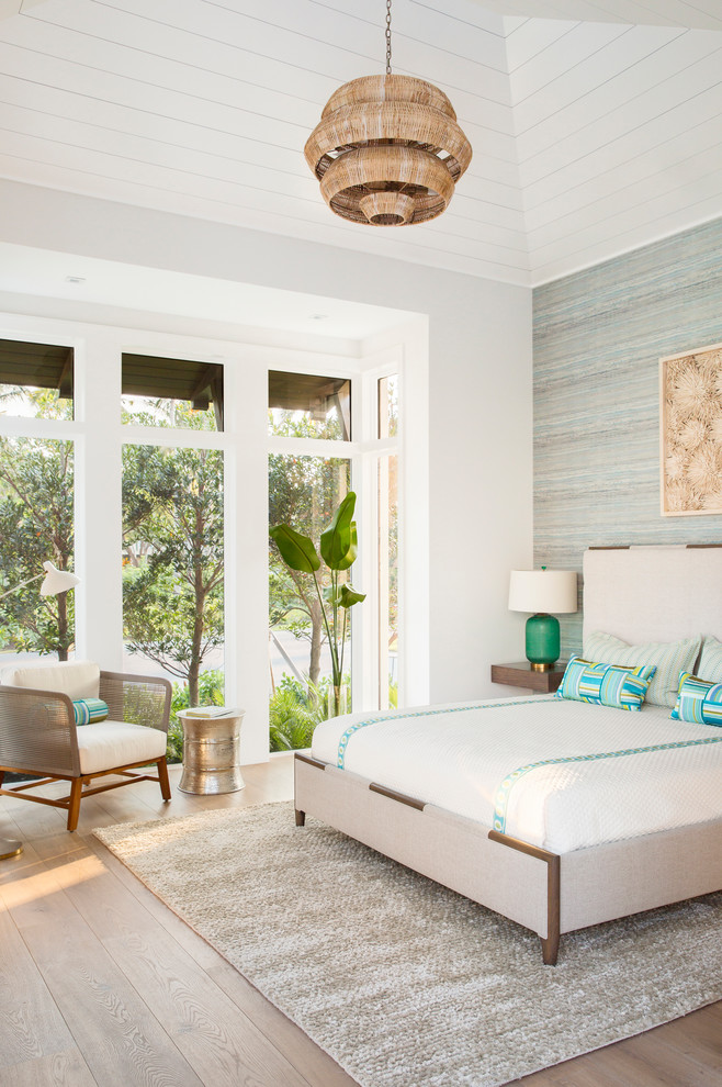 Design ideas for a coastal bedroom in Other with blue walls, medium hardwood flooring and brown floors.