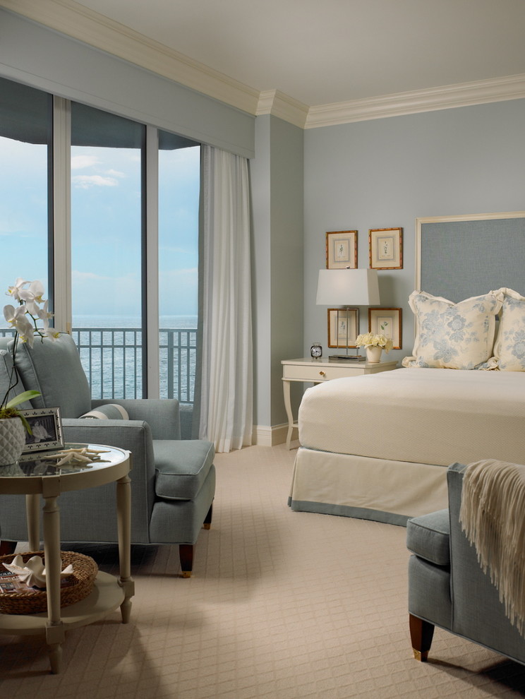 Example of a beach style carpeted bedroom design in Miami with blue walls