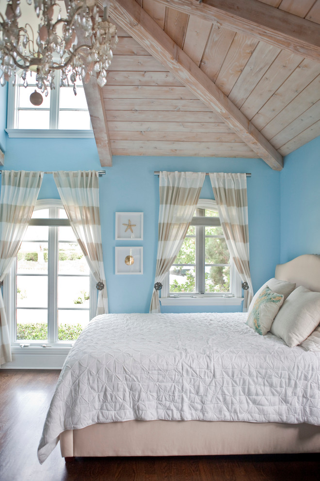 Large coastal guest bedroom in San Diego with blue walls.