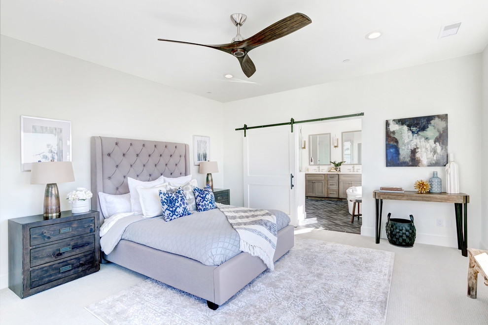 Beach style master carpeted and gray floor bedroom photo in San Diego with gray walls