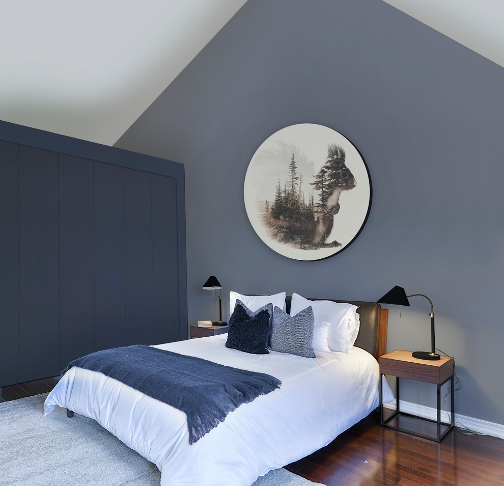 Idée de décoration pour une grande chambre parentale minimaliste avec parquet foncé, un mur gris, aucune cheminée et un sol marron.