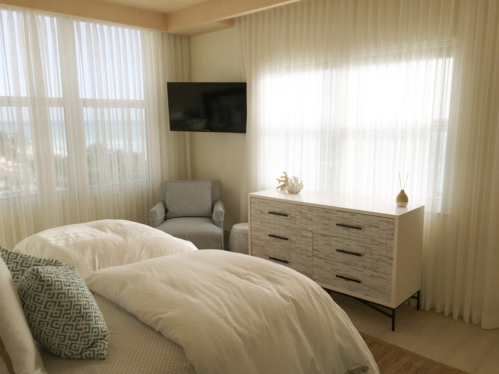 Modelo de dormitorio principal costero de tamaño medio con paredes blancas y suelo de baldosas de cerámica