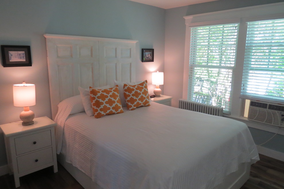 Photo of a medium sized beach style master bedroom in Boston with blue walls and medium hardwood flooring.