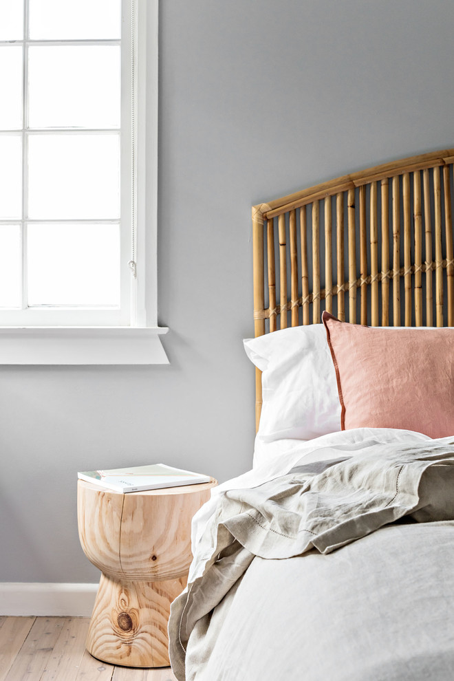 Medium sized coastal master bedroom in Sydney with grey walls, light hardwood flooring and beige floors.