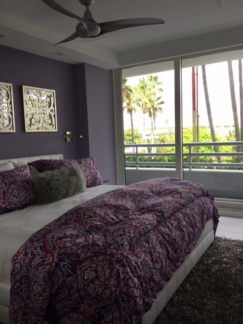Design ideas for a medium sized scandinavian master bedroom in Miami with purple walls.