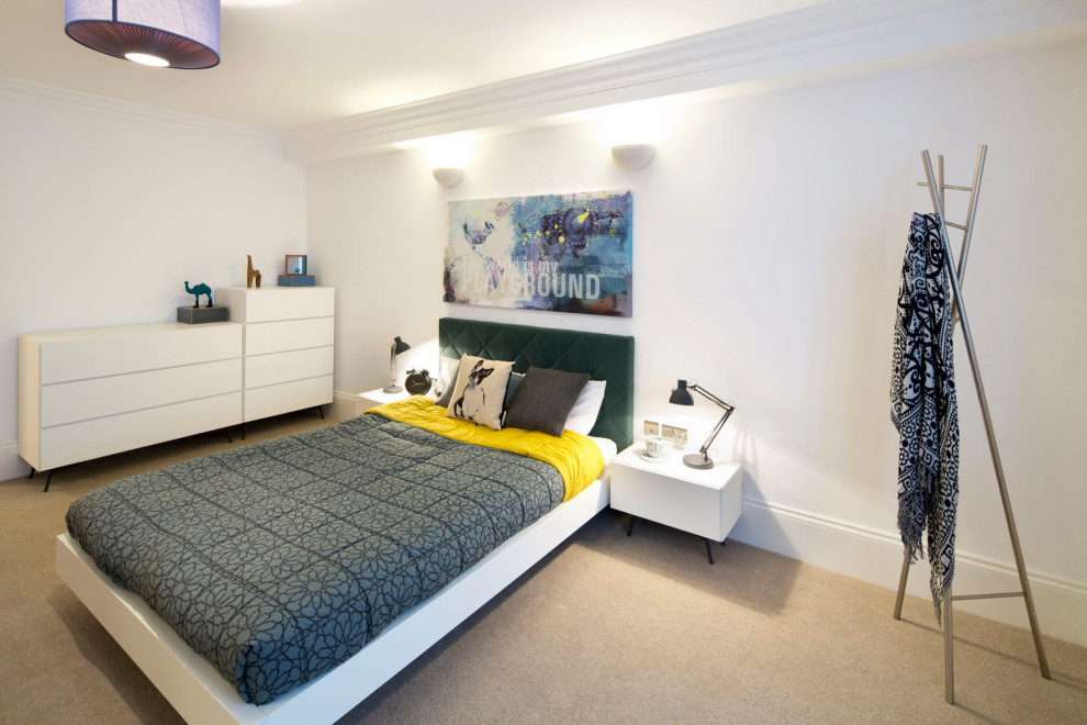 Photo of a large contemporary guest bedroom in Glasgow with white walls, carpet and beige floors.