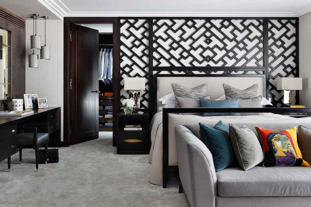 This is an example of a large contemporary master bedroom in London with grey walls and carpet.