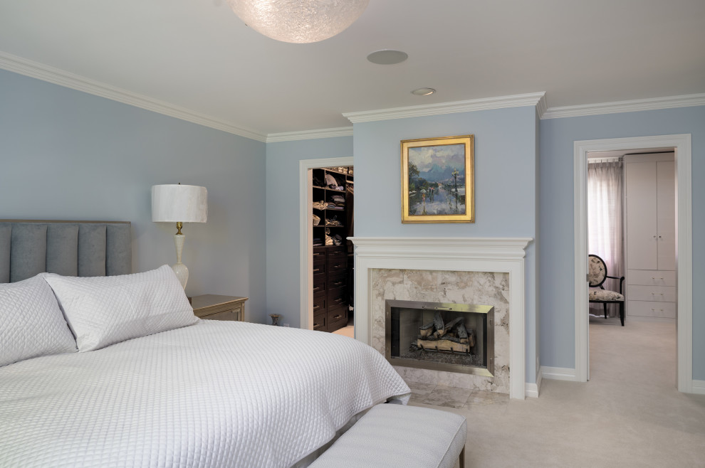 Idées déco pour une grande chambre classique avec un mur bleu, une cheminée standard, un manteau de cheminée en carrelage et un sol beige.