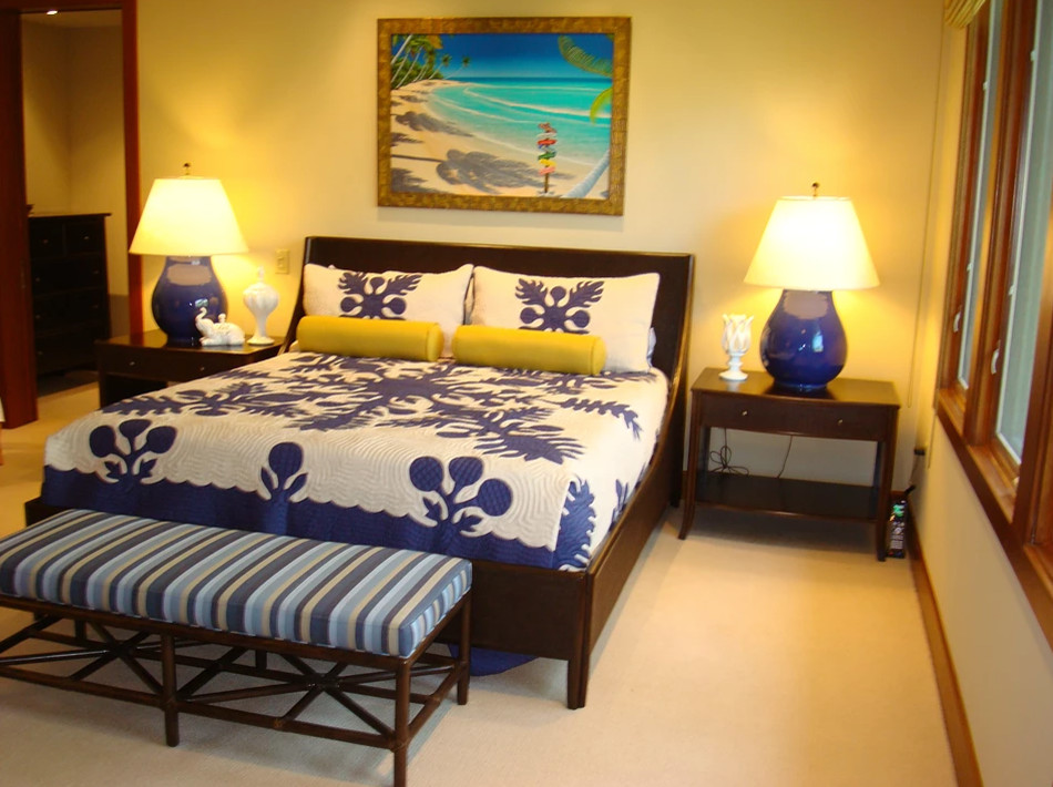 Inspiration for a large tropical master carpeted and beige floor bedroom remodel in Portland with beige walls and no fireplace