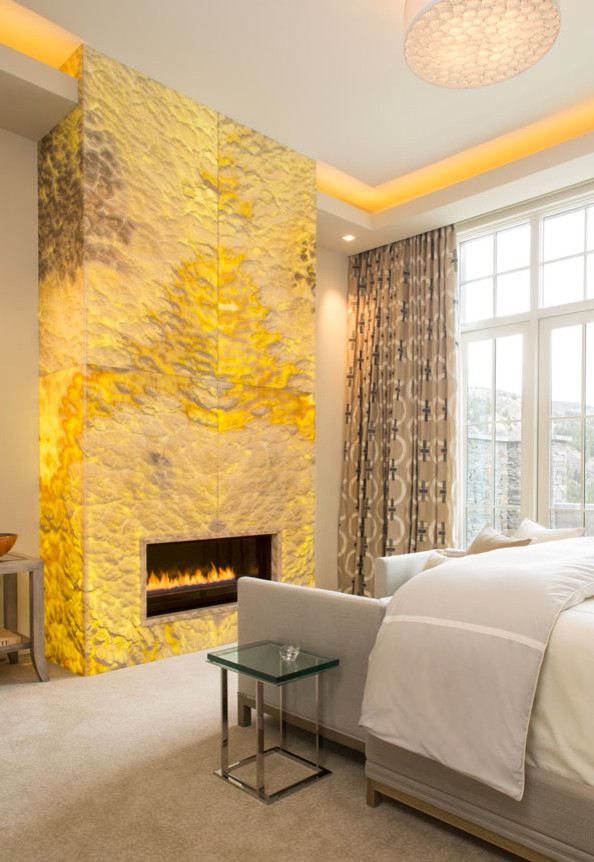 Inspiration for a large master carpeted bedroom remodel in Denver with beige walls and a standard fireplace