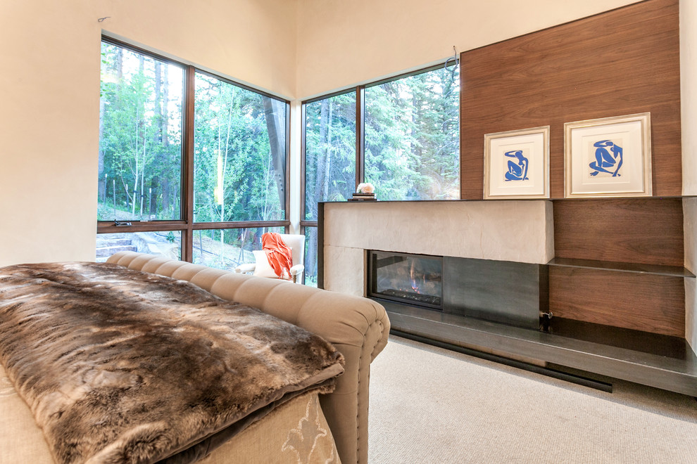 Large mountain style guest carpeted and beige floor bedroom photo in Denver with white walls, a standard fireplace and a metal fireplace