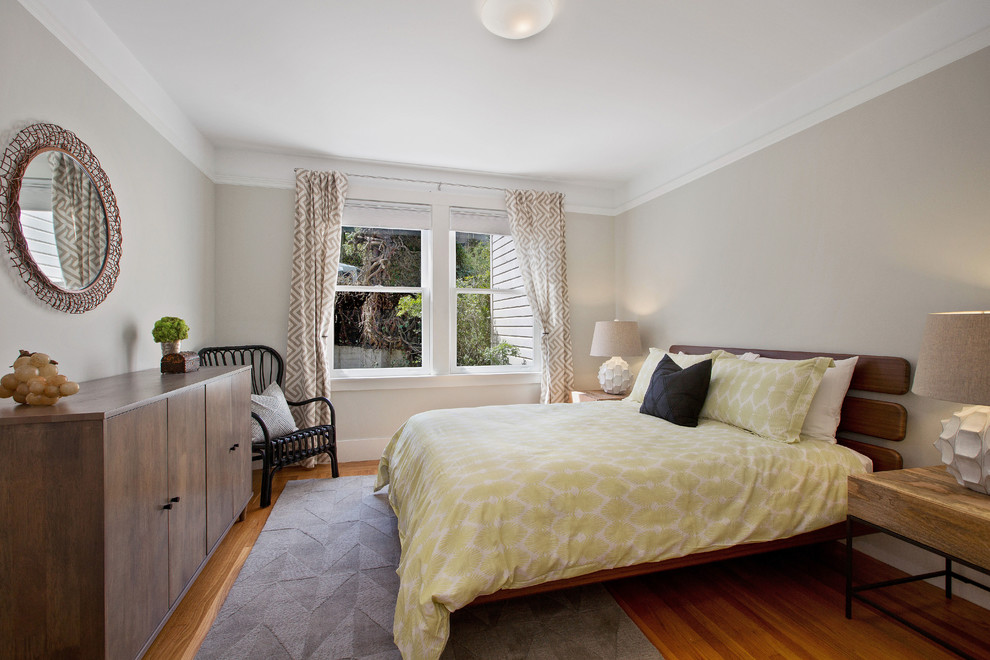 Mid-sized eclectic guest medium tone wood floor bedroom photo in San Francisco with gray walls