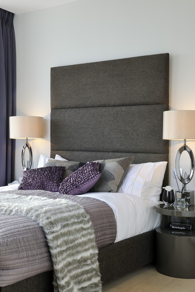 Contemporary grey and purple bedroom in London.