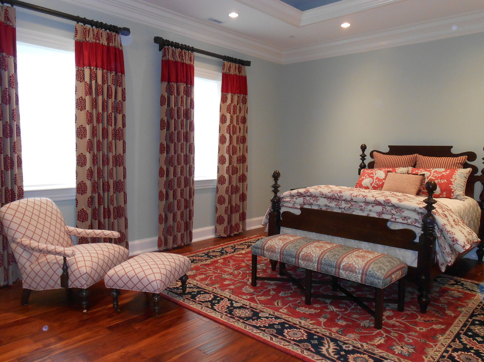 This is an example of a large classic guest bedroom in Cleveland with dark hardwood flooring and green walls.