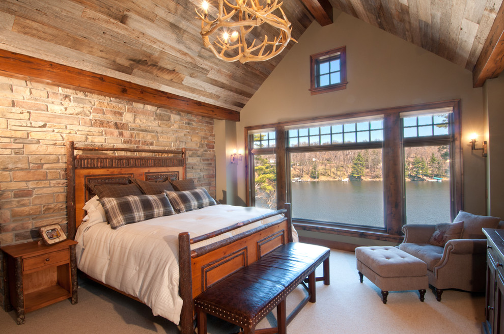 Inspiration for a rustic bedroom in Minneapolis with beige walls and carpet.