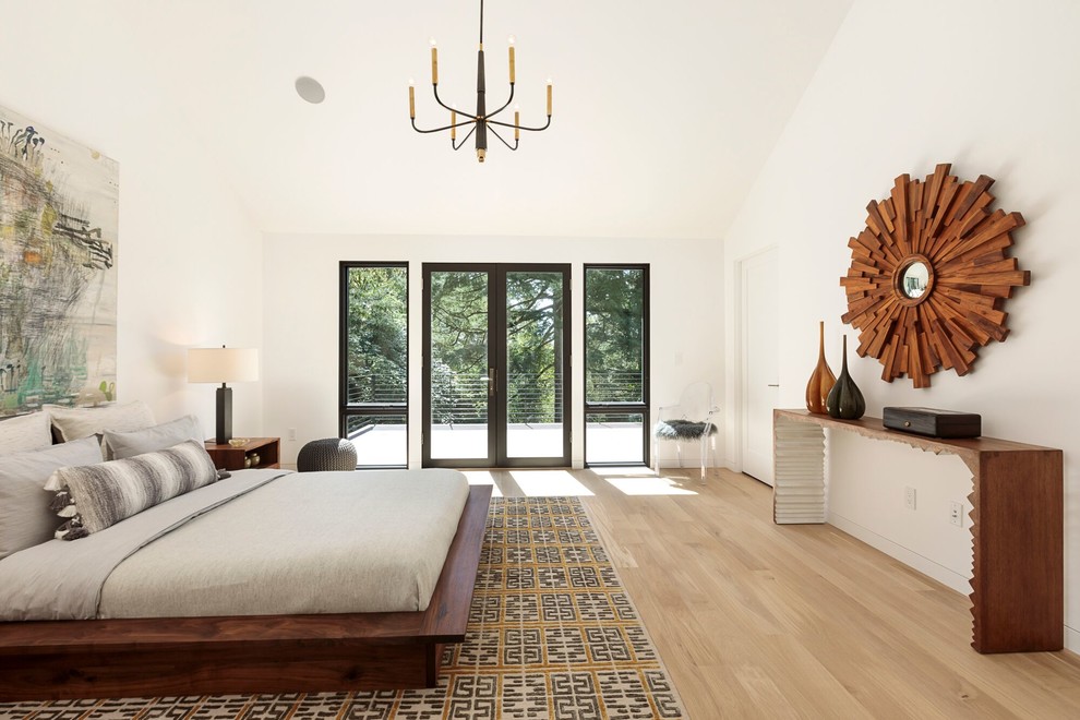 Design ideas for a scandinavian master bedroom in Portland with white walls, light hardwood flooring and no fireplace.