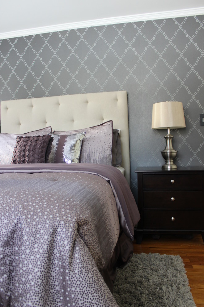 Photo of a traditional grey and cream bedroom in New York with medium hardwood flooring.