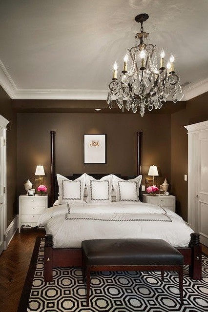 Example of a transitional master medium tone wood floor bedroom design in Houston with gray walls