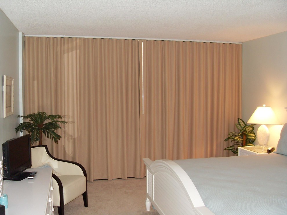 Example of a mid-sized classic guest carpeted and beige floor bedroom design in Miami with beige walls and no fireplace