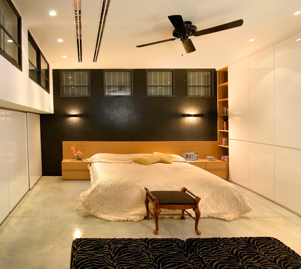 Eclectic bedroom in Other with concrete flooring and a feature wall.