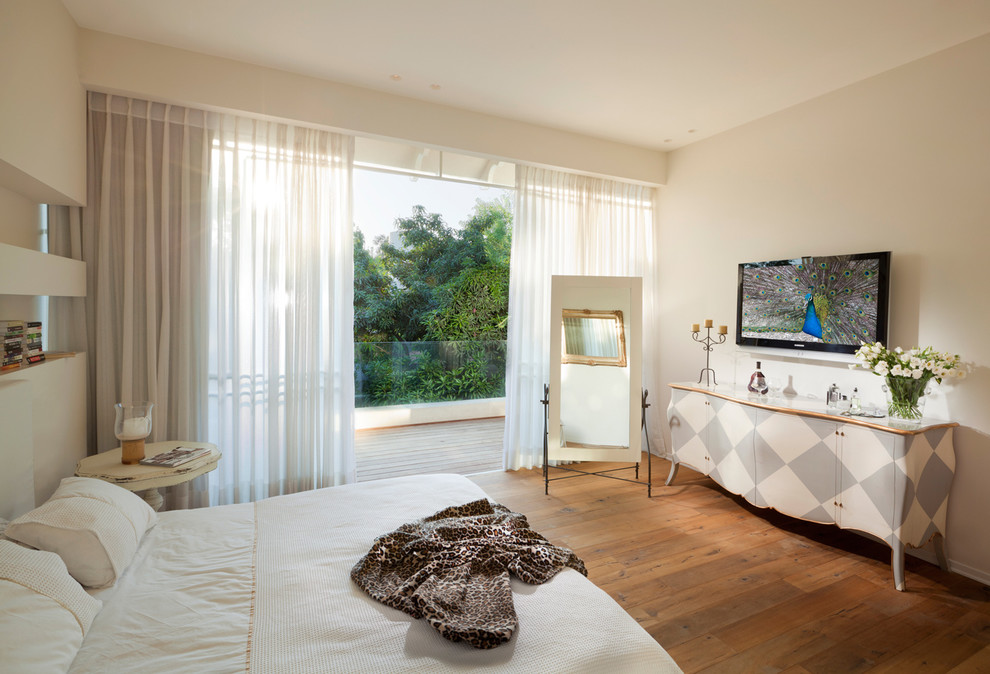 Bedroom - eclectic medium tone wood floor bedroom idea in Other with beige walls